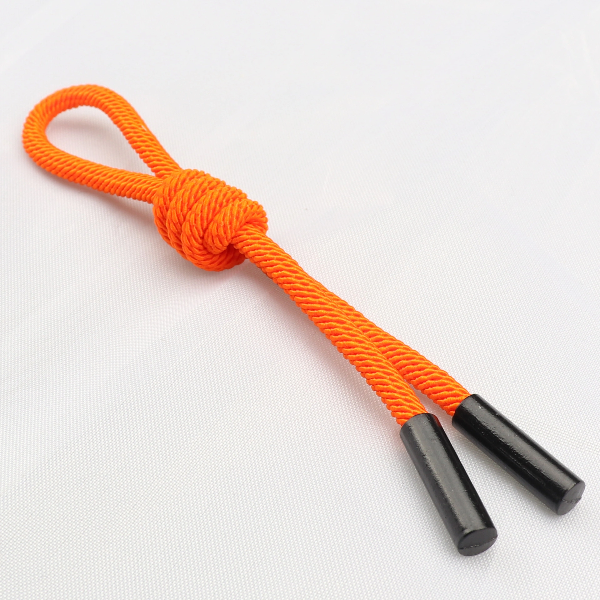 Close-up of the coiled knot on an orange rope charm